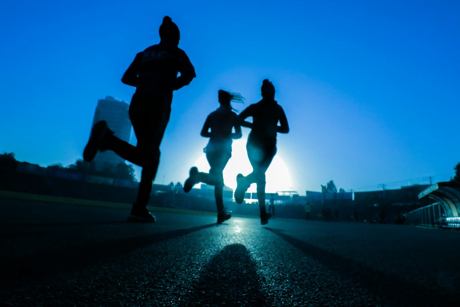 Runners on a track at a high school meet